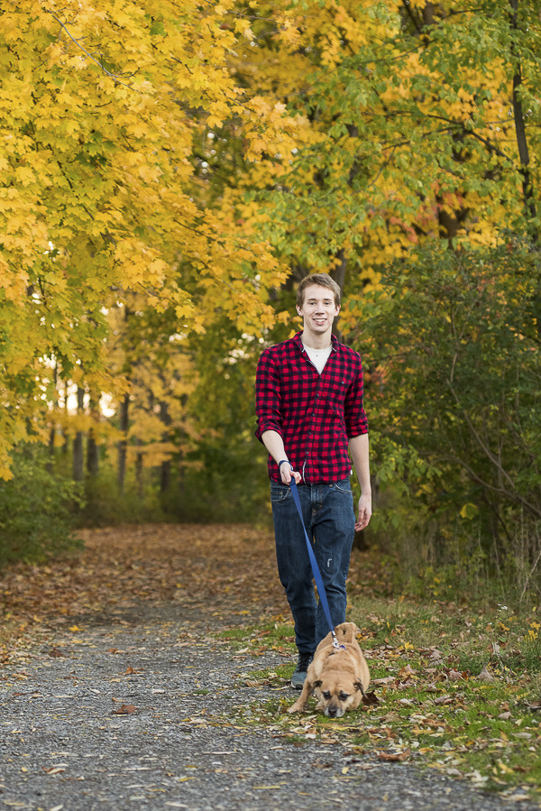 guy in red flannel shirt walking Puggle, fall day in CNY