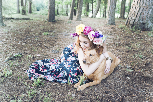 woman with floral crown hugging dog outside, lifestyle dog-human photos