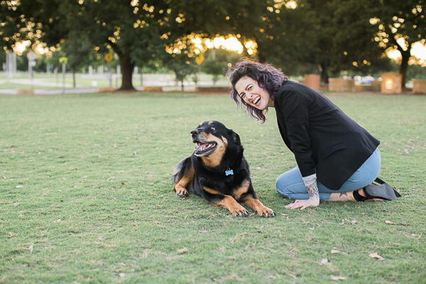 dog smiling, woman laughing at park, devoted human-dog relationship