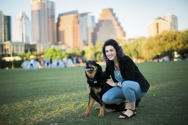 Shepherd mix, woman at park, cityscape in background