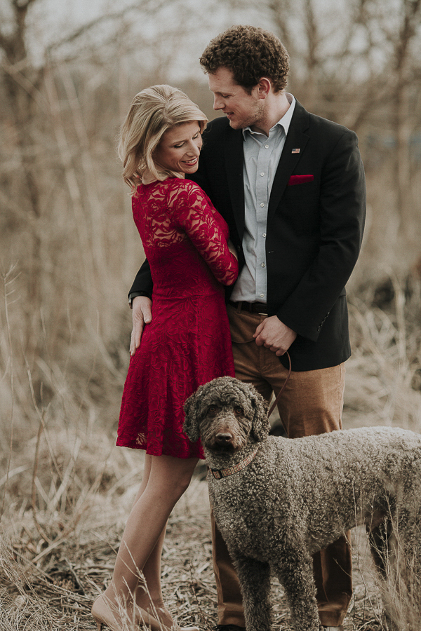 couple in field, winter engagement pictures with dog, Labradoodle