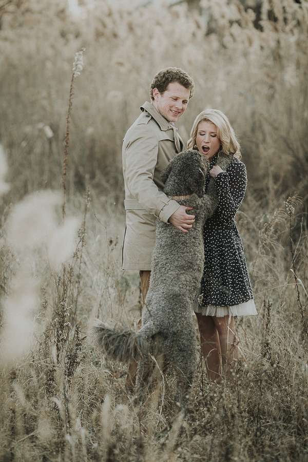 dog jumping up on woman during winter engagement photo session