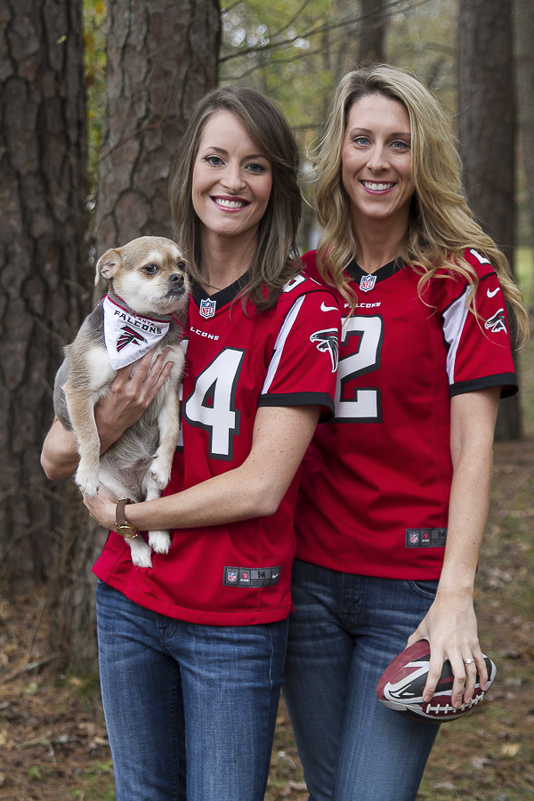 women wearing Falcon jerseys, dog wearing Falcon bandana, engagement pictures with dog