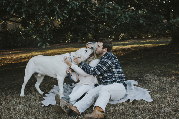 dog licking man's face during engagement session