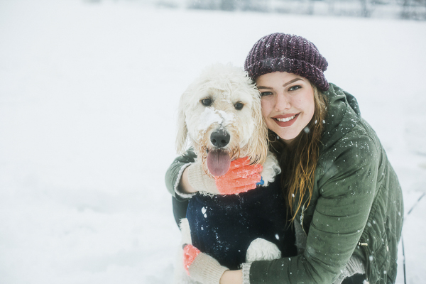 college student hugging dog, snowy portraits, NC lifesttyle photographer