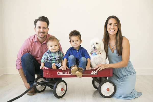 two little boys and dog in wagon between parents, family studio portraits