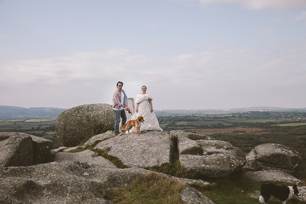 couple and dogs on large rock outcrop, 