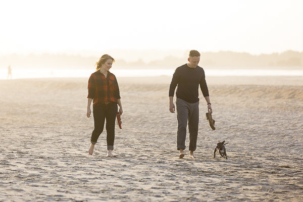 couple walking with puppy on the beach, ©Erin Costa Photography