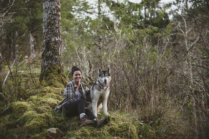 woman and her dog sitting on moss in forest, on location dog photography ©Laurie Jean Photography