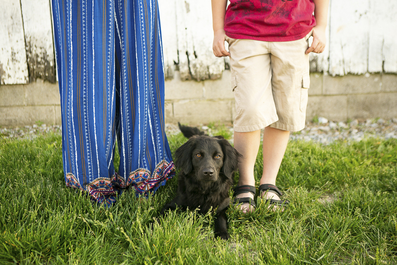 puppy laying between boy and his mom, family pictures with dogs, ©Mandy Whitley Photography