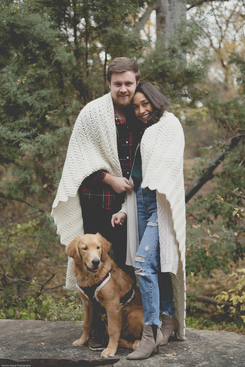 couple wrapped in ecru blanket, standing with their dog in front of them, engagement portrait ideas, dog friendly engagement poses | ©Tammy Klepac Photography 