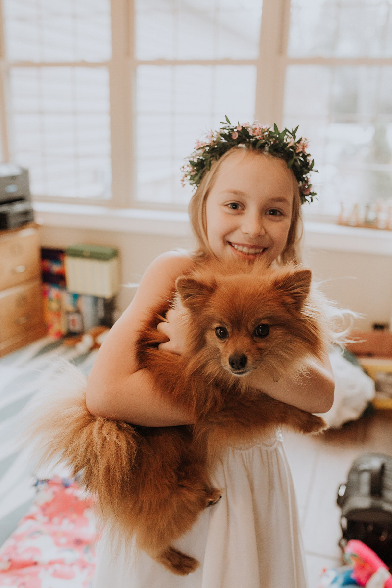 girl in first communion dress holding dog, ©Gardenhouse FIlms