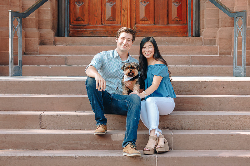 couple sitting on steps with Yorkie, dog-friendly engagement photos | ©Charleston Photo Art